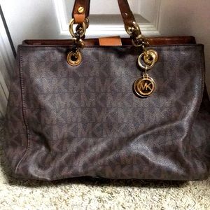 Michael Kors monogrammed handbag with detail strap